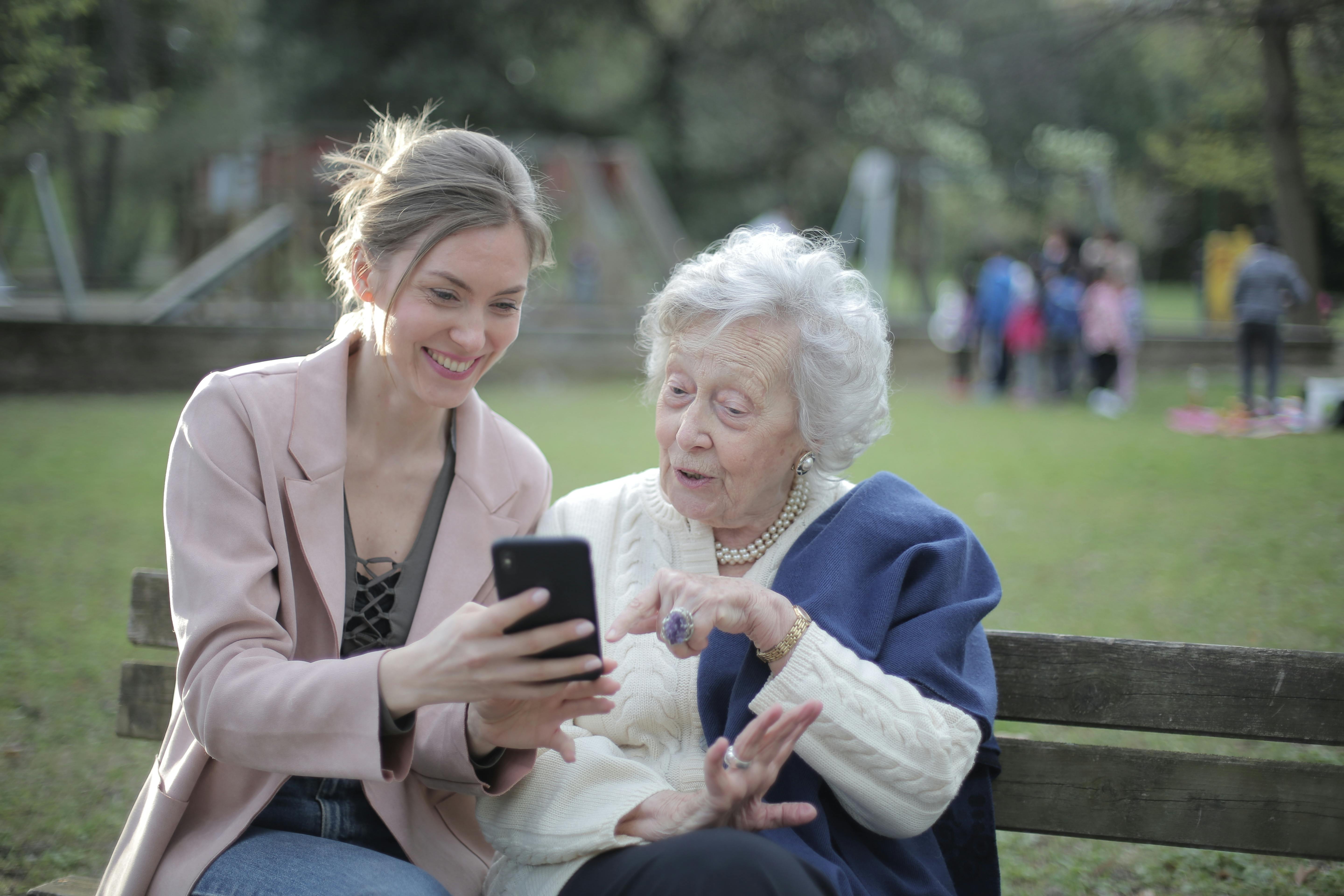 two women looking at a phone screen